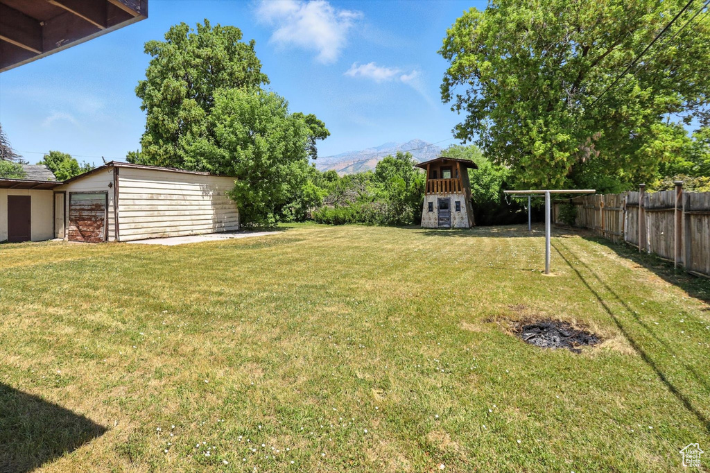 View of yard featuring a mountain view and an outdoor structure