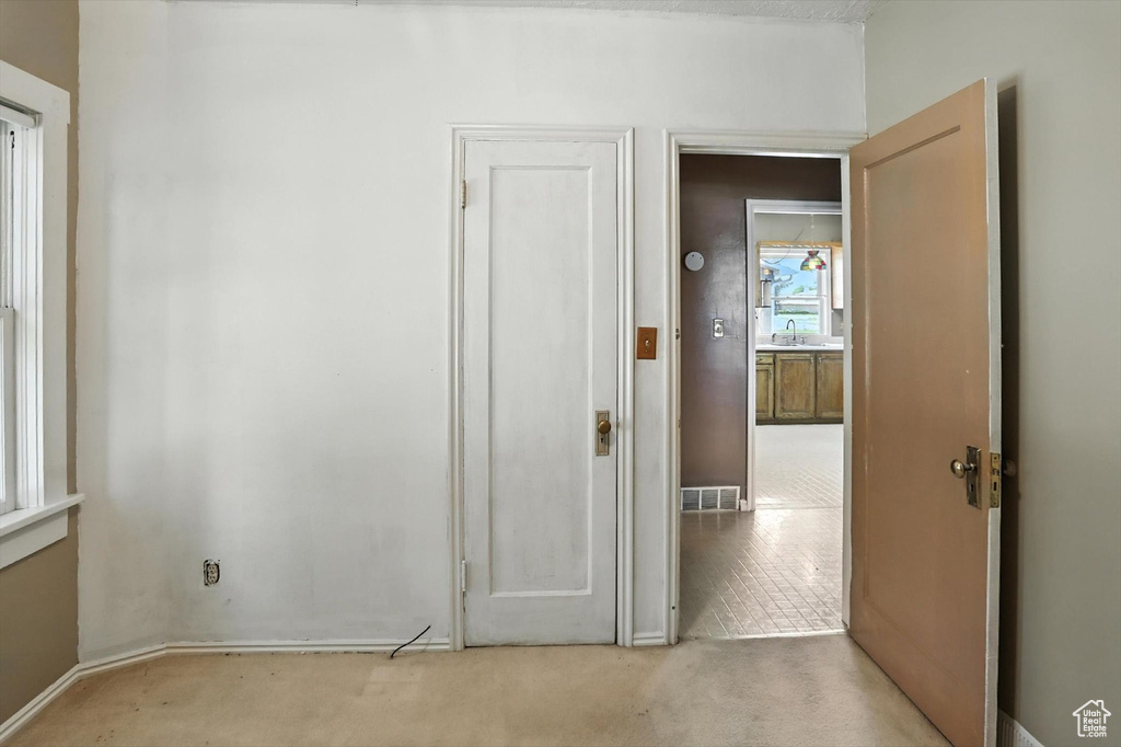 Hallway featuring carpet flooring and baseboards
