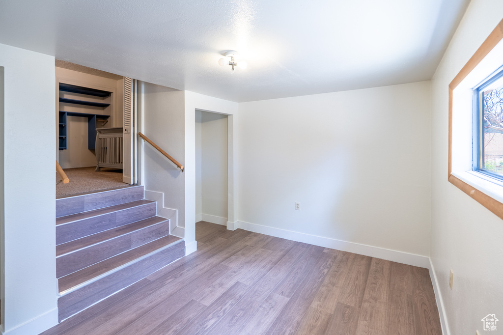 Empty room featuring wood finished floors and stairs