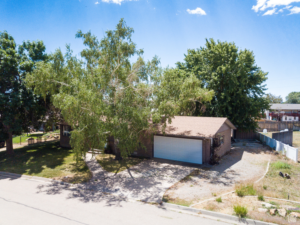 Obstructed view of property with concrete driveway