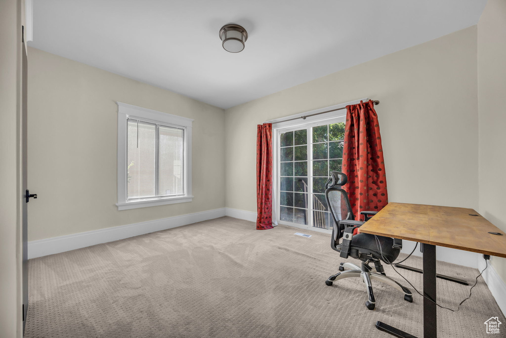 Carpeted office space with baseboards