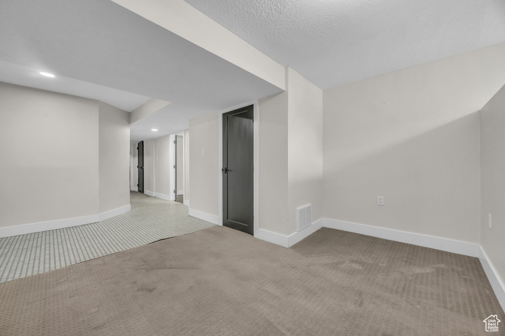 Carpeted spare room with recessed lighting