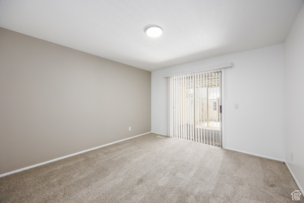 Carpeted spare room with baseboards