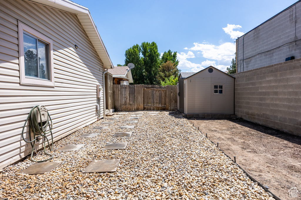 Fenced backyard with a storage shed