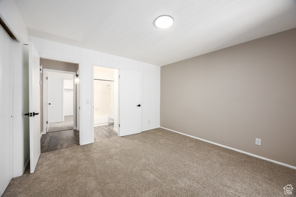 Unfurnished bedroom featuring carpet, a closet, and ensuite bathroom