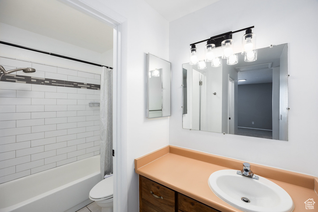 Full bathroom featuring vanity and shower / bath combo with shower curtain