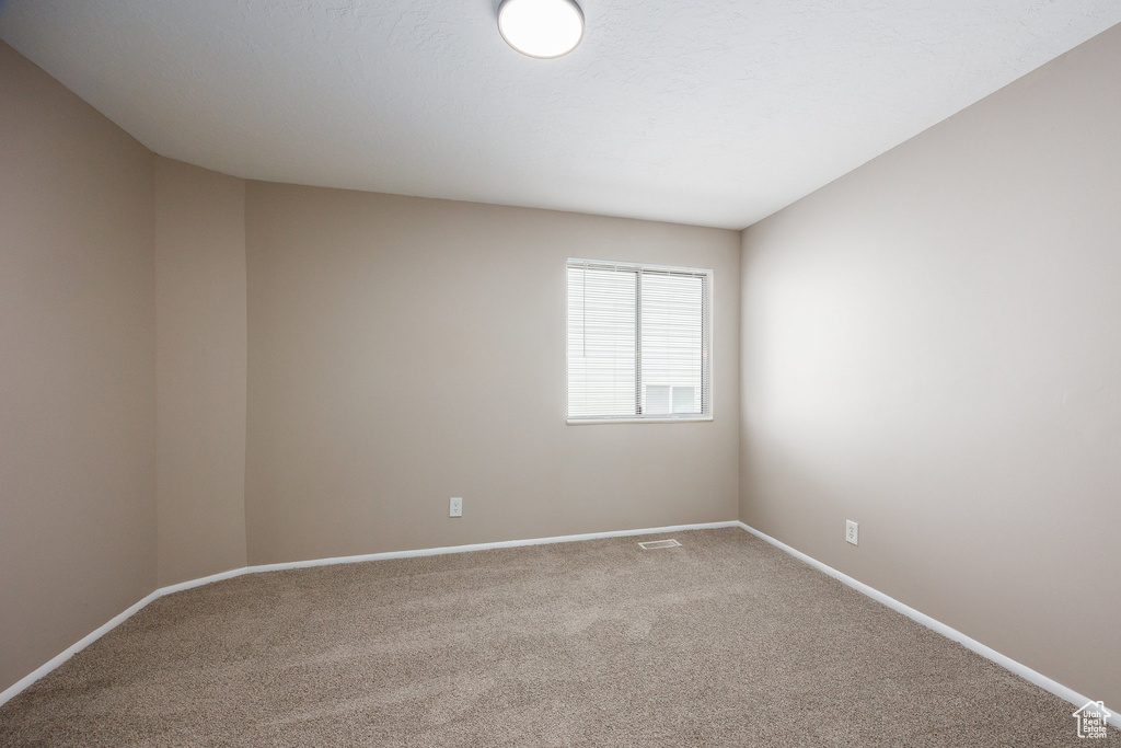 Spare room featuring carpet