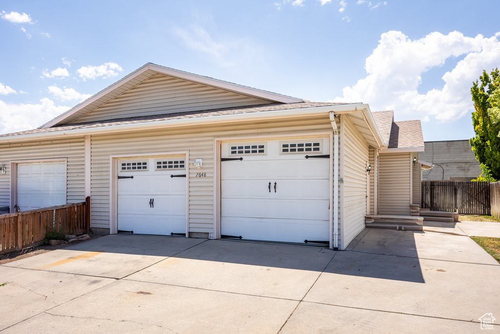 Garage featuring concrete driveway