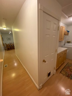 Corridor featuring light wood finished floors