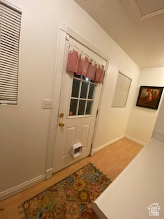Entrance foyer featuring light wood-type flooring and baseboards