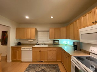 Kitchen with white appliances, light brown cabinetry, light wood finished floors, and recessed lighting