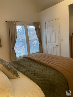 Bedroom with lofted ceiling