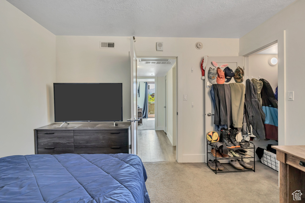Carpeted bedroom featuring baseboards