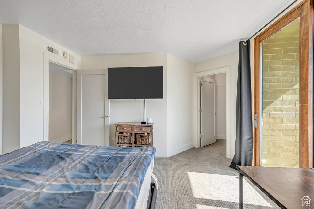 Carpeted bedroom featuring baseboards
