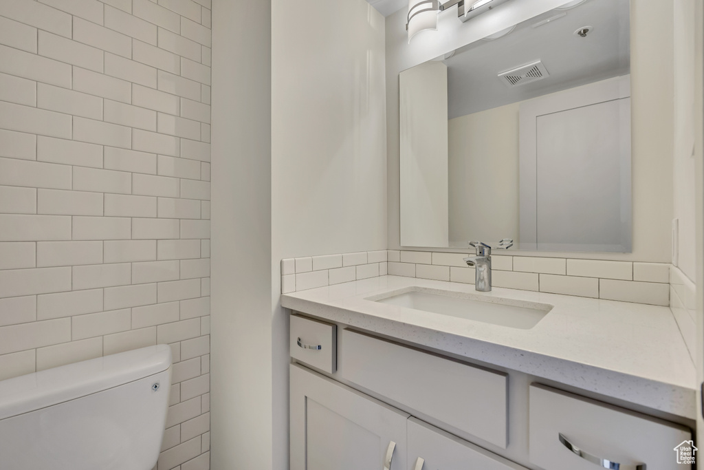 Half bath featuring vanity and toilet