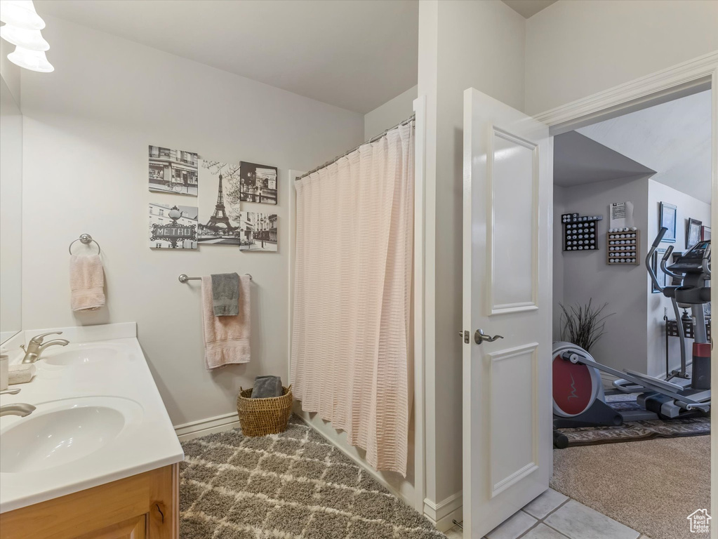 Full bathroom with double vanity and a shower with shower curtain