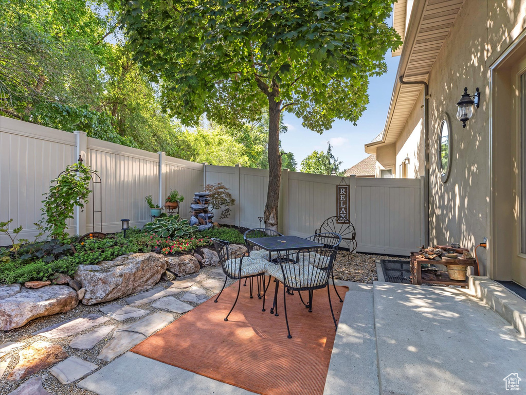 Fenced backyard with outdoor dining space and a patio