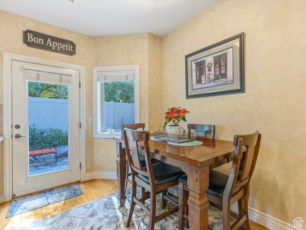 Dining room featuring light wood-type flooring and baseboards