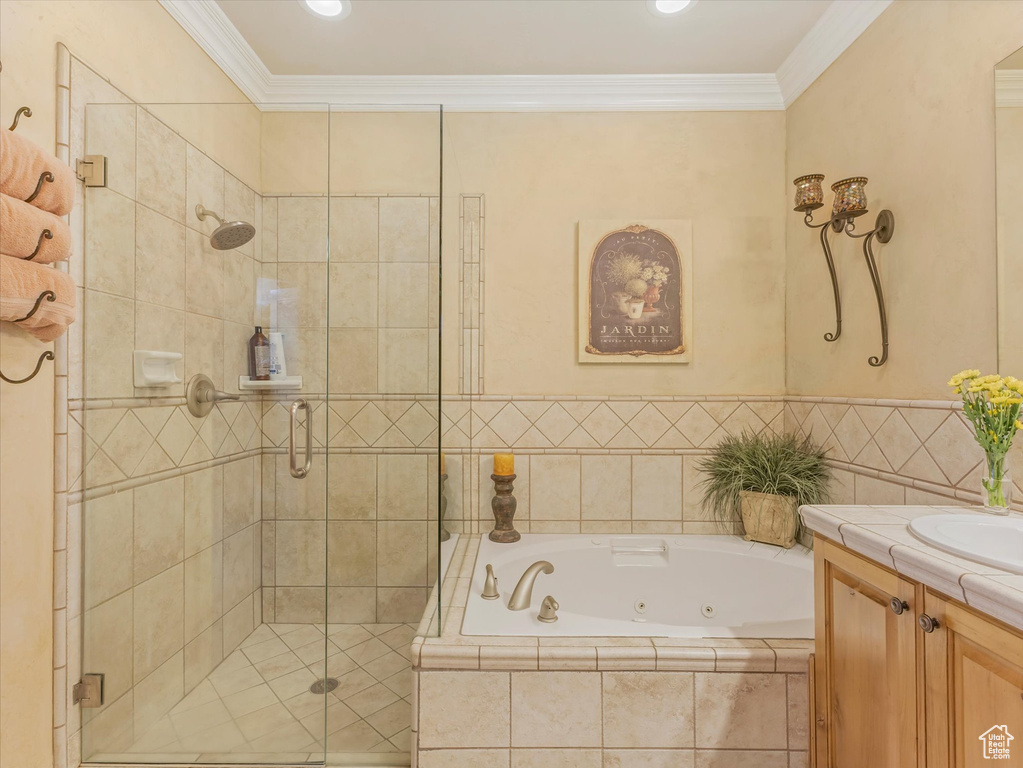 Full bath featuring a whirlpool tub, a stall shower, vanity, and crown molding