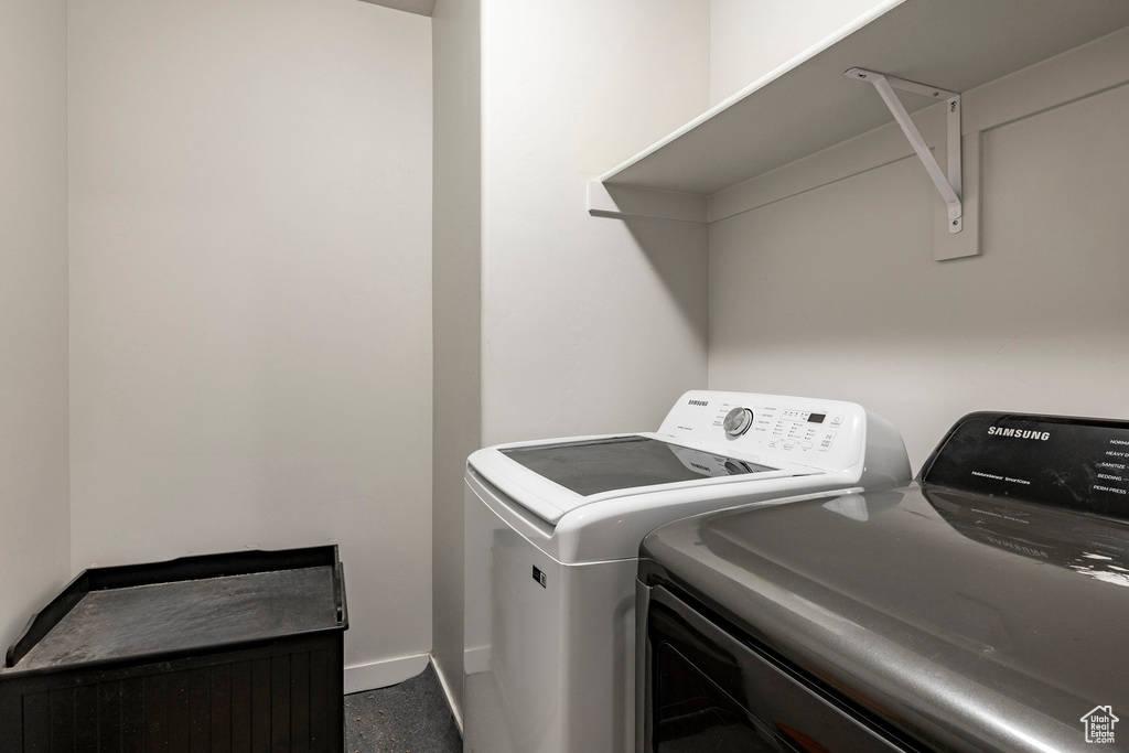 Laundry room with separate washer and dryer and baseboards