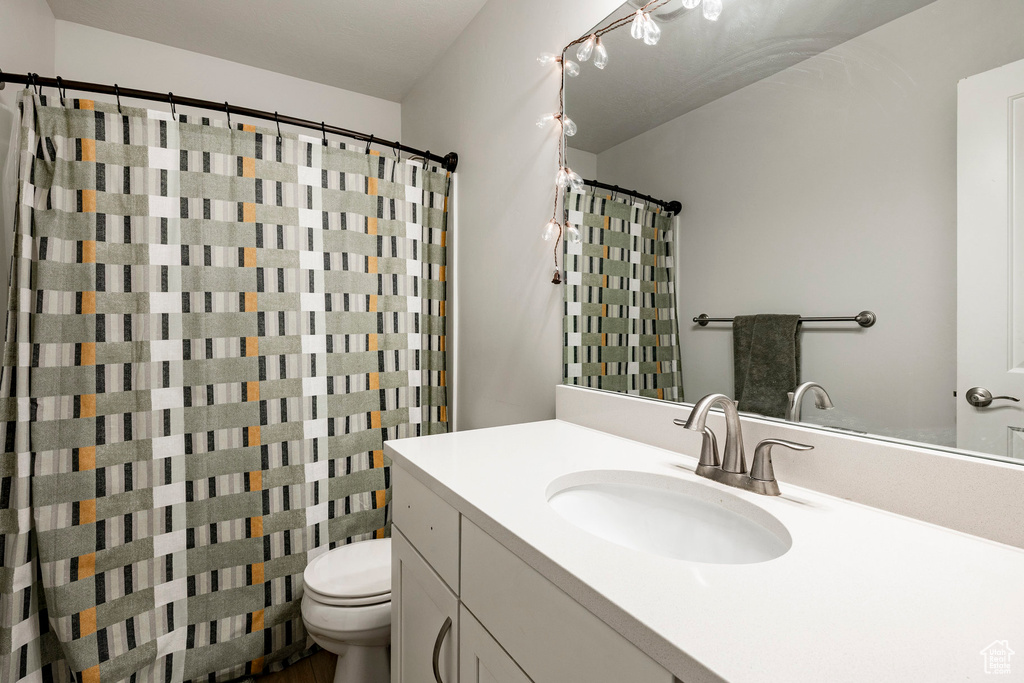Full bathroom featuring vanity and a shower with shower curtain