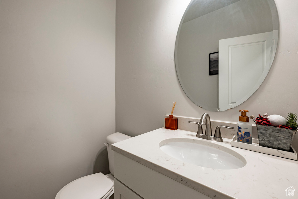 Half bathroom with vanity and toilet