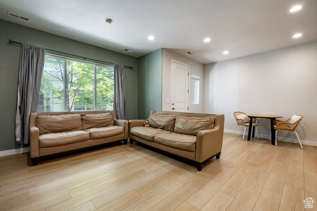 Living room featuring recessed lighting and light wood-type flooring