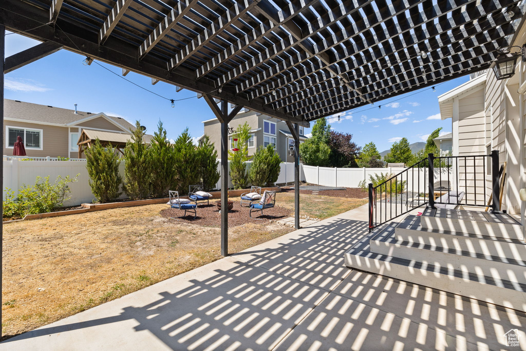 Fenced backyard with a patio area and a pergola