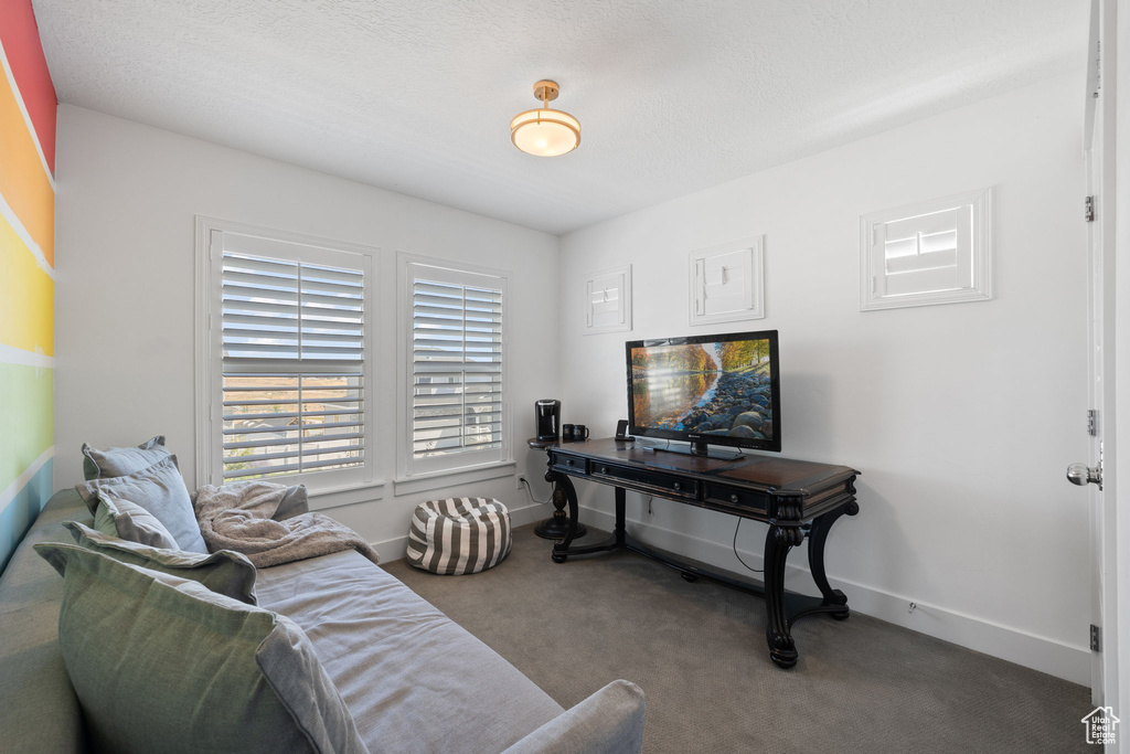 Living room featuring carpet flooring and baseboards