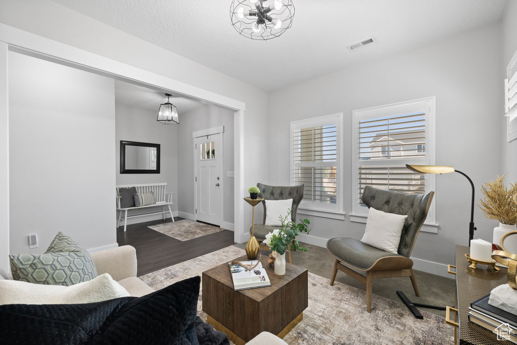 Living room with a chandelier and wood finished floors