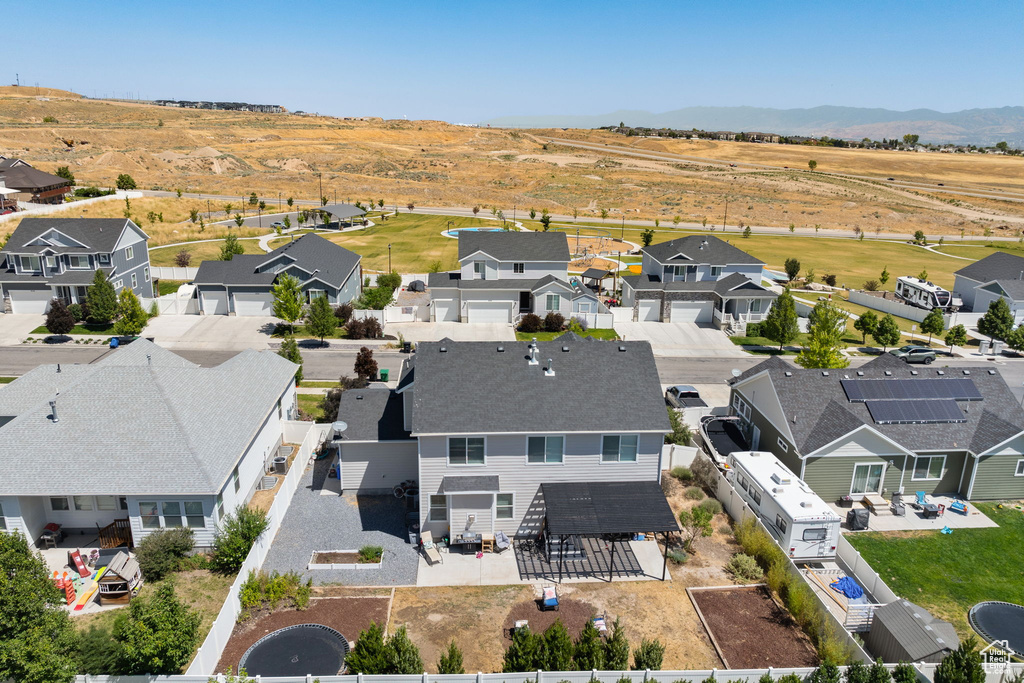 Aerial perspective of suburban area with a mountainous background