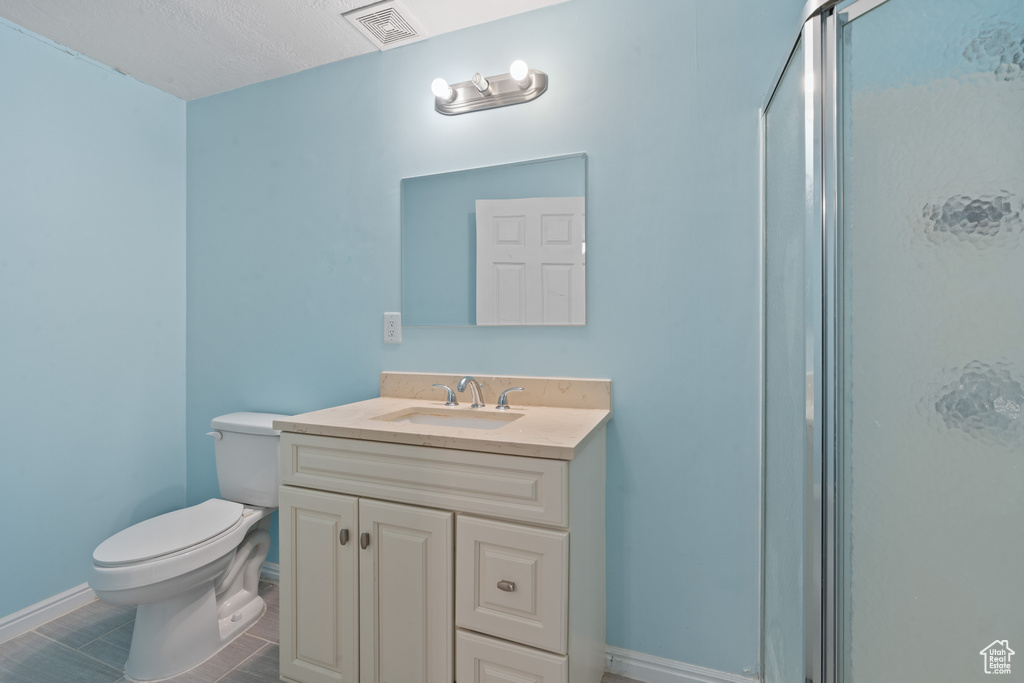 Bathroom with a shower with door and vanity