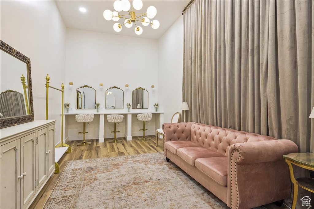 Bathroom featuring wood finished floors, a chandelier, and vanity
