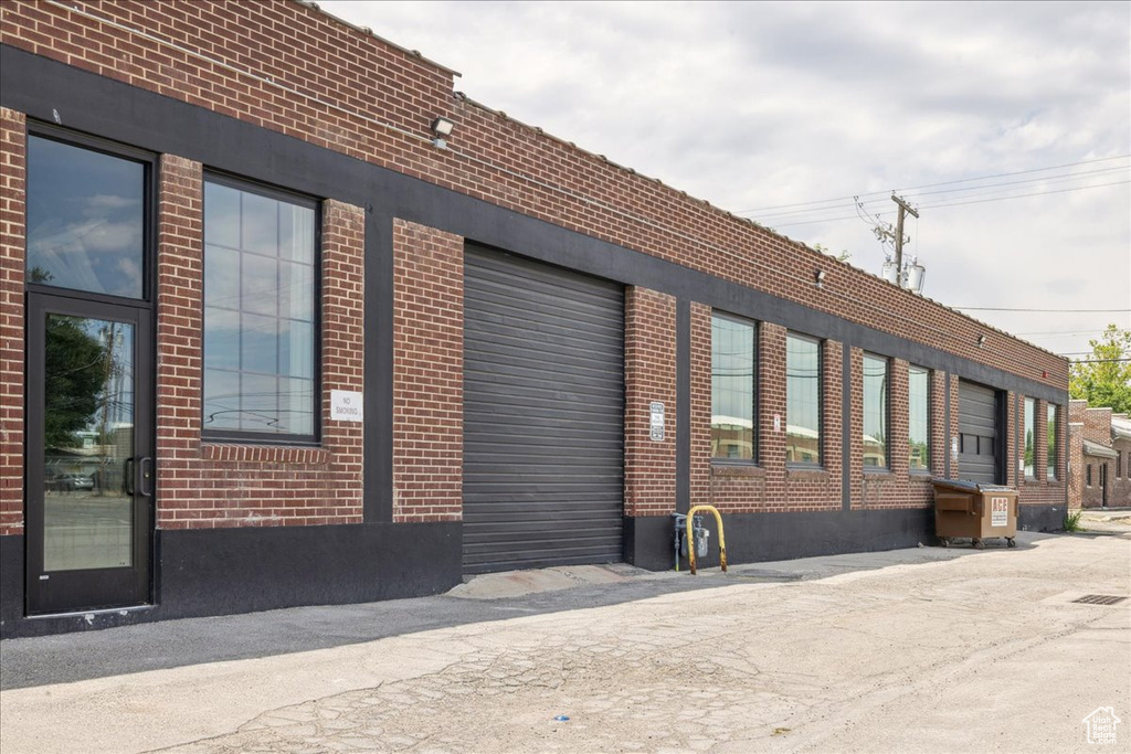 View of building exterior with an attached garage