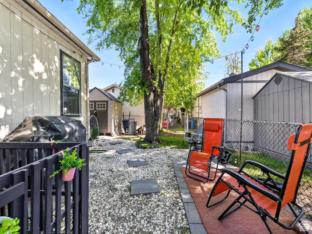 View of patio featuring a storage unit