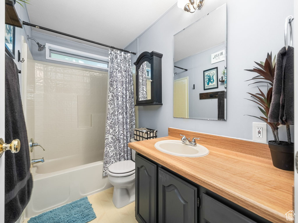 Bathroom featuring vanity and shower / bath combo