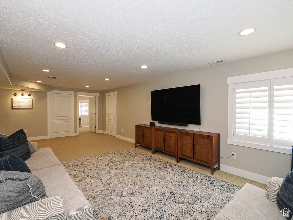 Living room featuring recessed lighting and a textured ceiling