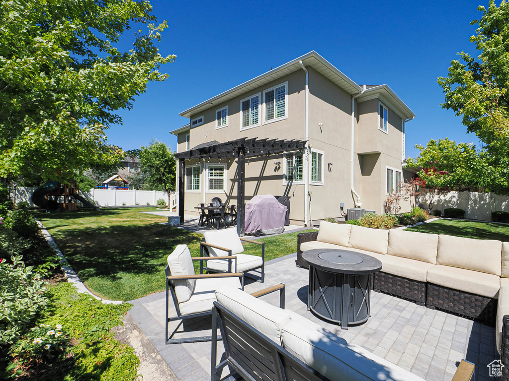 Fenced backyard featuring an outdoor living space, a pergola, a patio area, and grilling area
