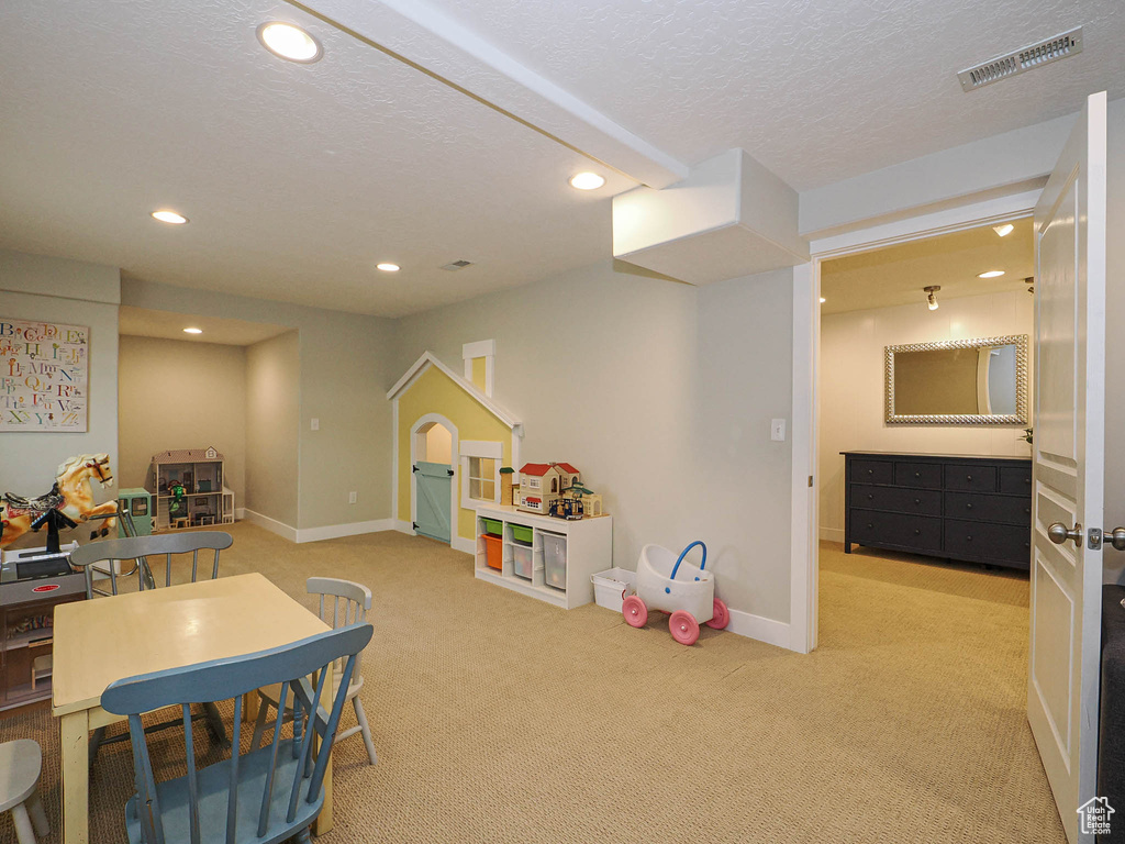Playroom with recessed lighting, carpet floors, and a textured ceiling