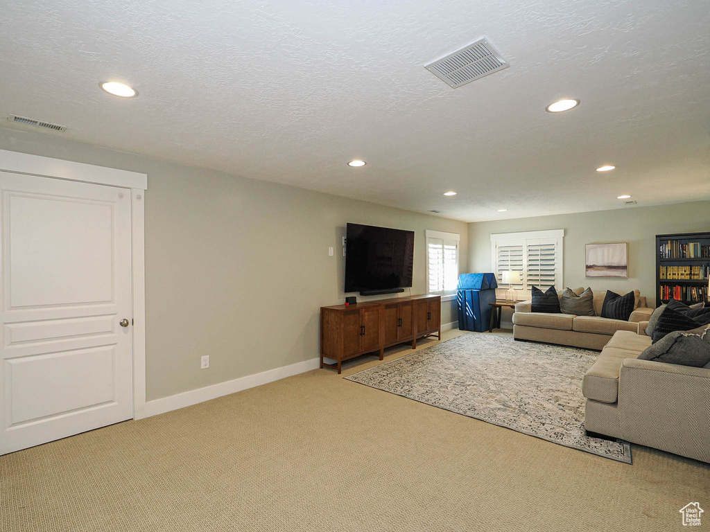 Living room with carpet flooring and recessed lighting