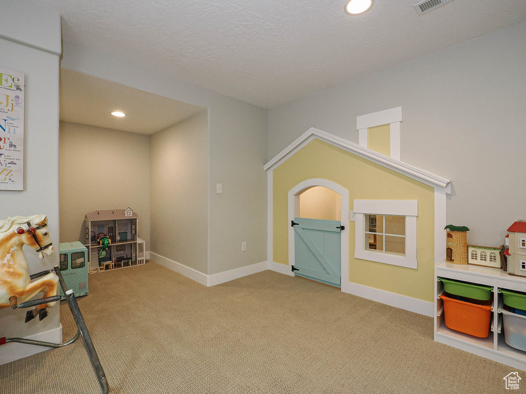 Playroom with carpet floors, recessed lighting, and a textured ceiling