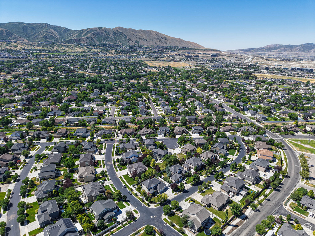 Aerial view of property and surrounding area with a mountain backdrop