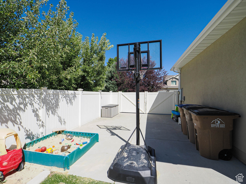 Fenced backyard featuring a patio and a gate