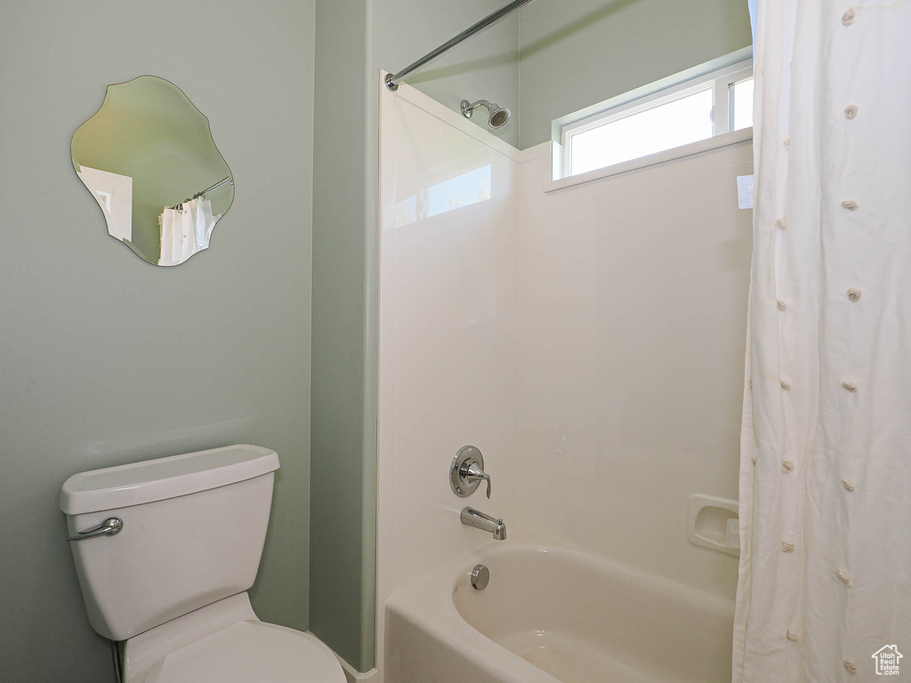 Full bathroom with shower / bath combo and toilet
