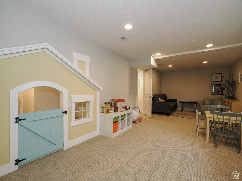 Playroom featuring carpet flooring, recessed lighting, and a textured ceiling