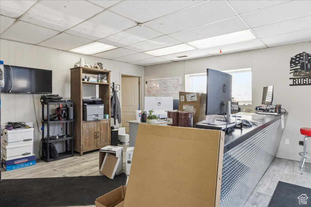 Miscellaneous room with wood finished floors, a drop ceiling, and a desk