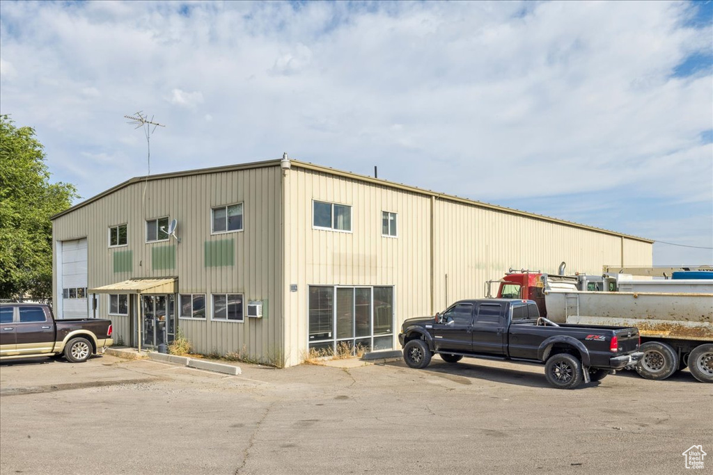 View of building exterior featuring uncovered parking