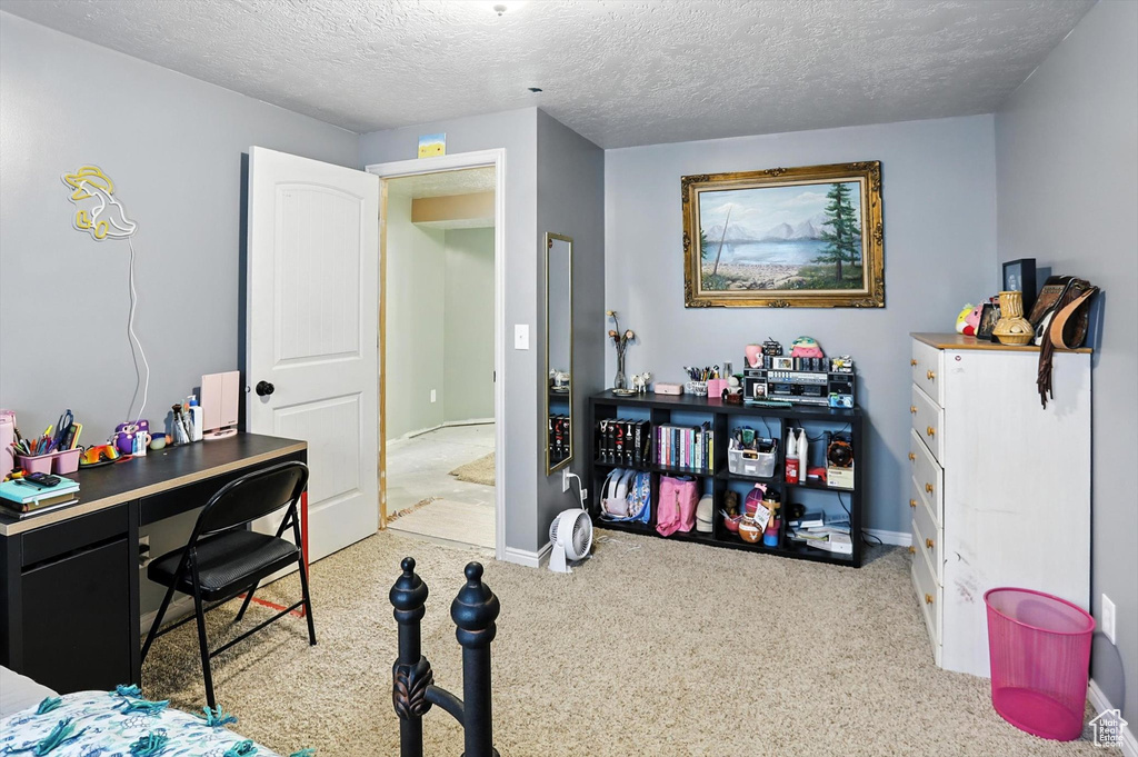 Bedroom with carpet and a textured ceiling