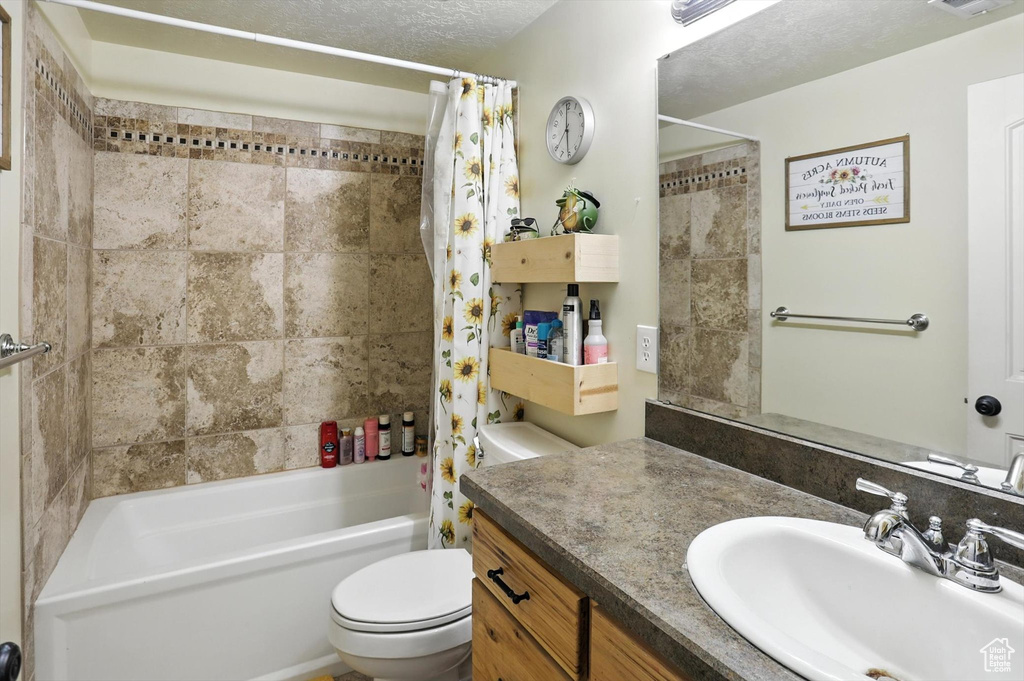 Full bathroom featuring vanity and shower / tub combo with curtain