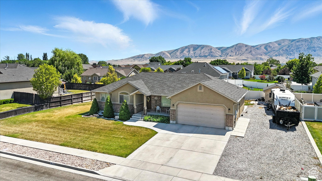 View of front facade with a residential view, a garage, stucco siding, and concrete driveway